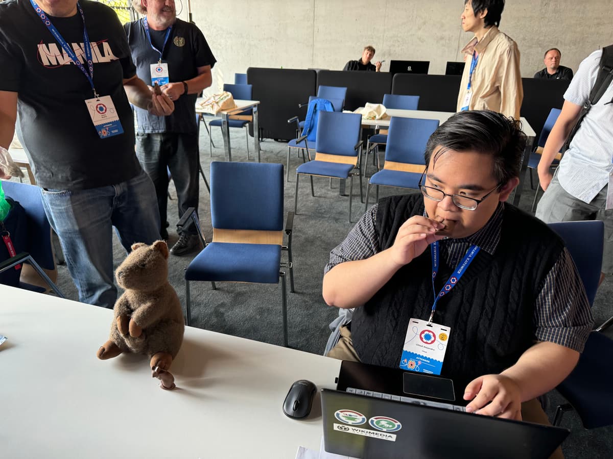 Chlod eating quokka chocolate in front of quokka, the ESEAP mascot.